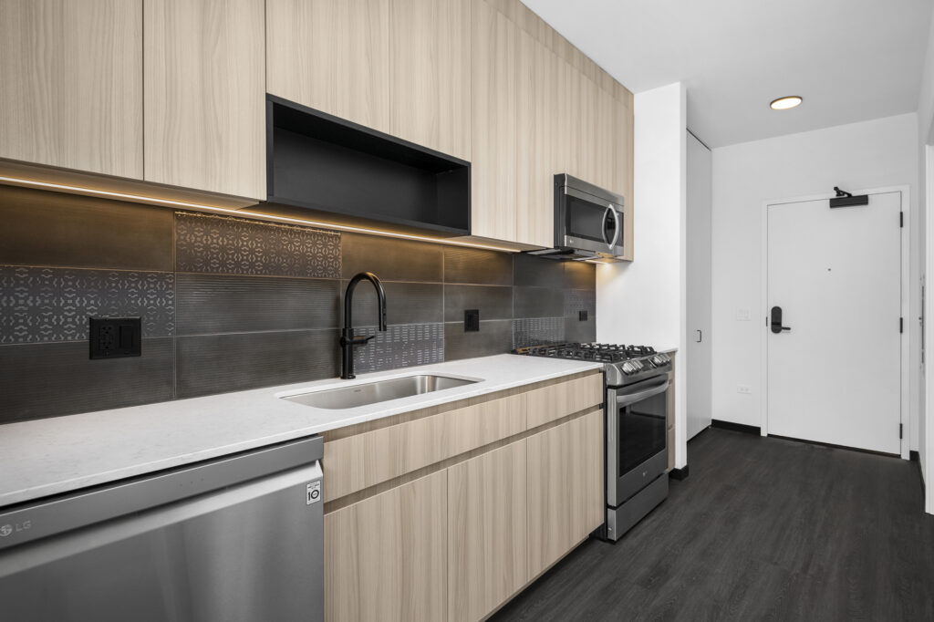 modern kitchen featuring ceramic backsplash, stainless steel appliances, and soft-close cabinets at Parq Fulton