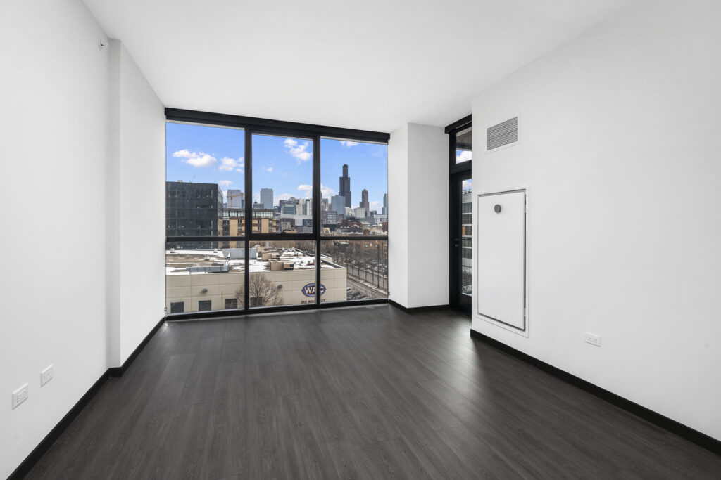 Parq Fulton apartment living room with plank flooring and floor-to-ceiling windows