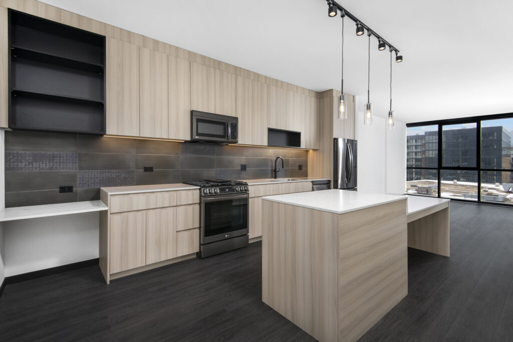 apartment kitchen with quartz countertops and stainless steel appliances
