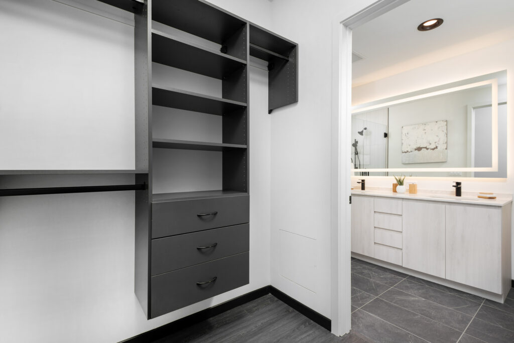built-in shelves in a closet opening up to a bathroom of a Parq Fulton apartment home