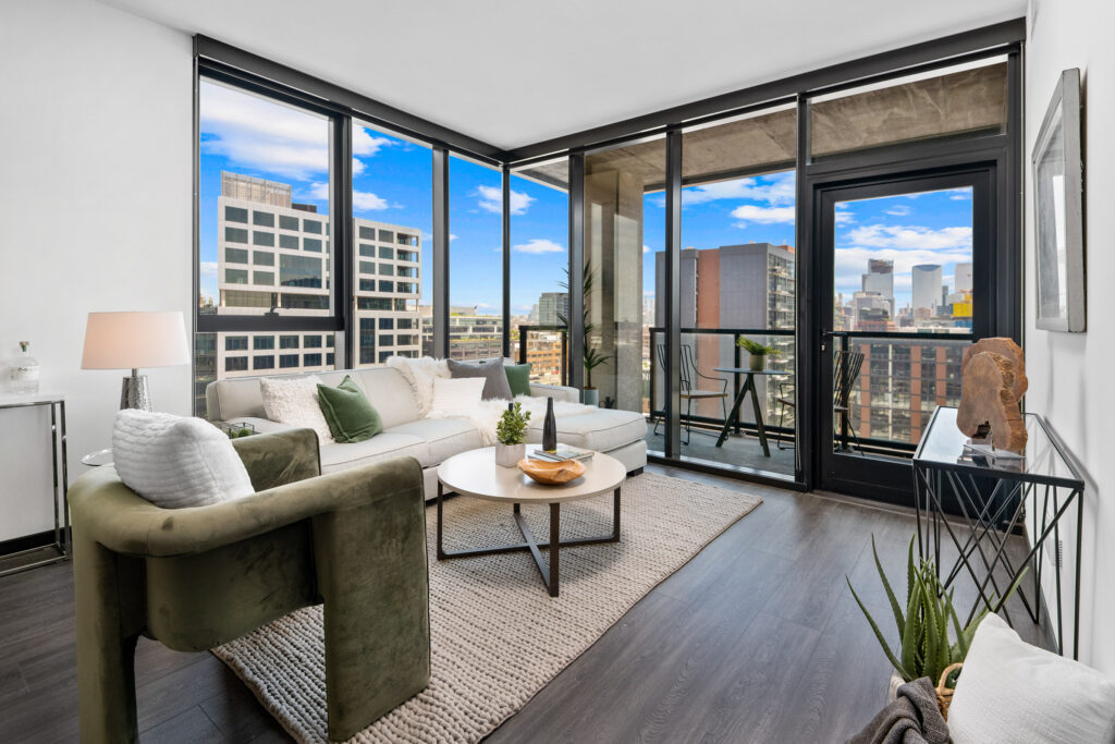 Parq Fulton apartment living room with modern furnishings and floor-to-ceiling windows overlooking Fulton Market