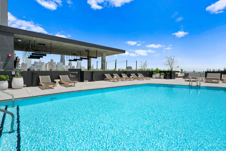 Rooftop sun deck with lounge seating and city views