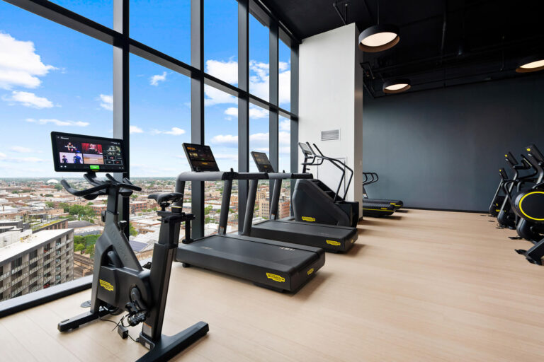 Fitness center cardio equipment overlooking downtown Chicago