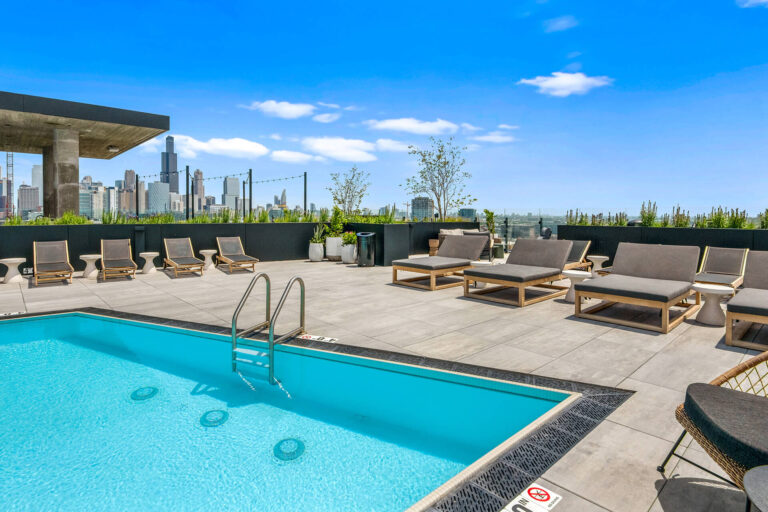 Rooftop swimming pool with city skyline views at Parq Fulton apartments